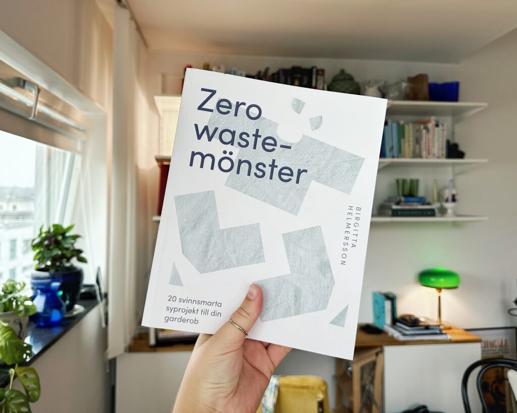 En hand håller upp boken Zero waste-mönster, som är perfekt för nybörjare.